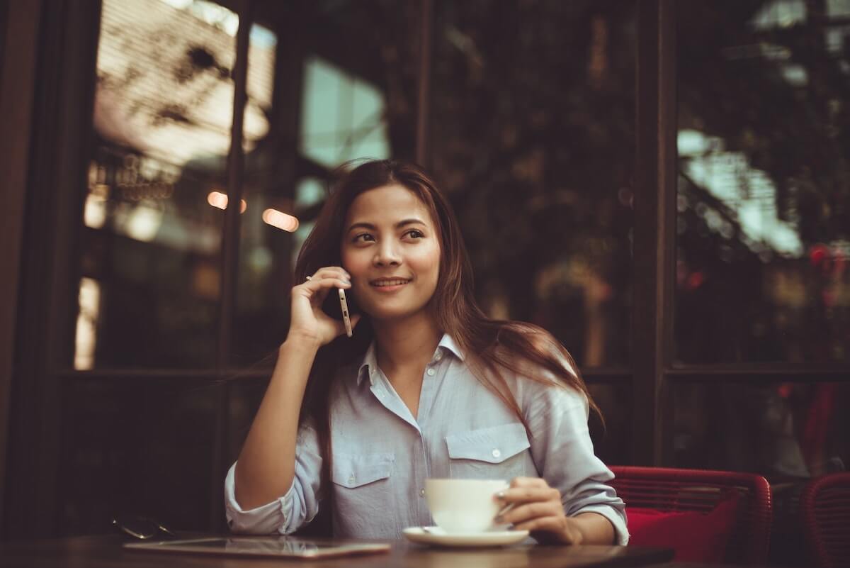 Woman at a cafe on the phone