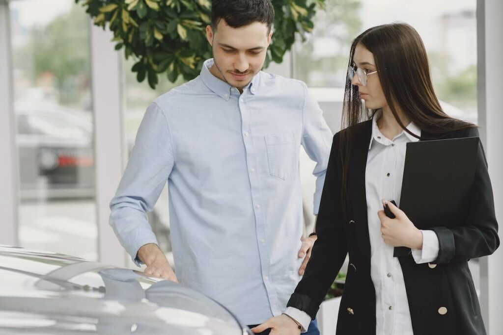 two people evaluating a car