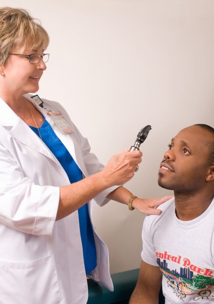 patient receiving an eye check as part of a health care visit